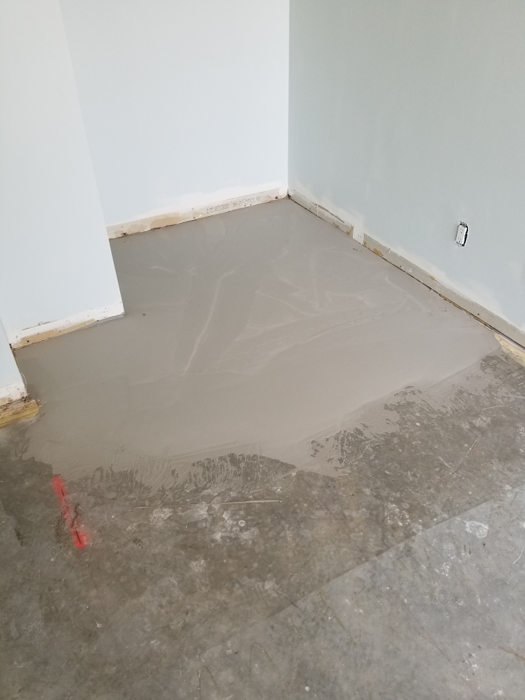 Self leveling concrete poured to level floor prior to hardwood flooring installation